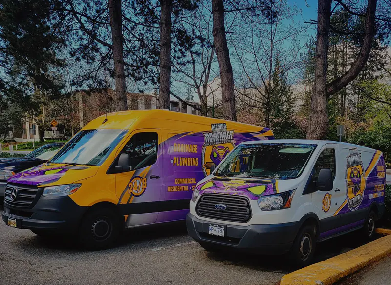 mamba-banner-temp Two Mamba Drainage service vans parked at a job