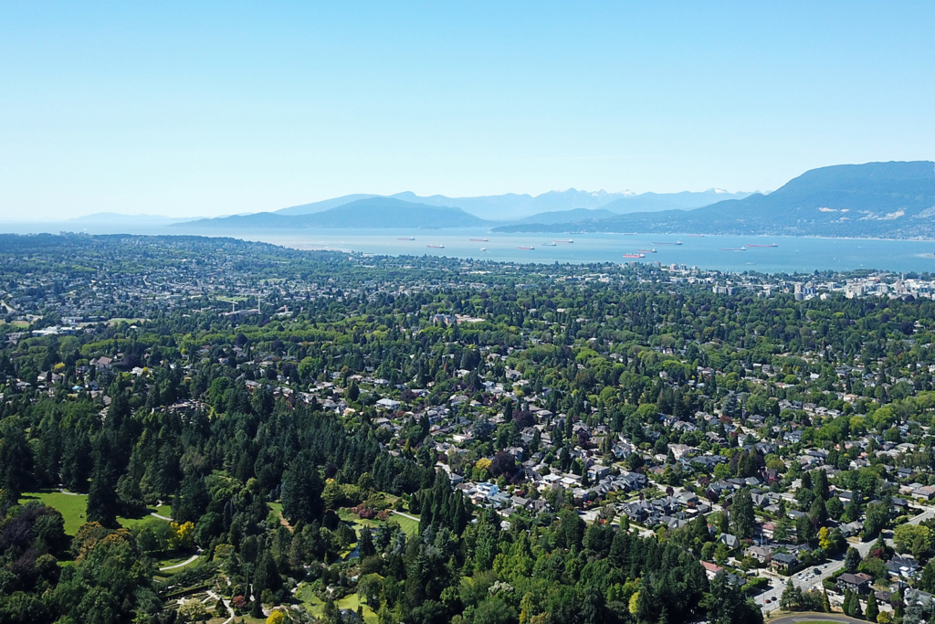 Shaughnessy, Vancouver Aerial view over the tree covered residential streets and mature canopy sloping northwest toward English Bay and the North Shore mountains in Shaughnessy, Vancouver