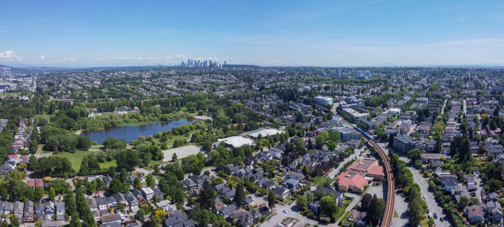 Aerial view over Trout Lake and the houses and tree lined streets of Kensington-Cedar Cottage, Vancouver