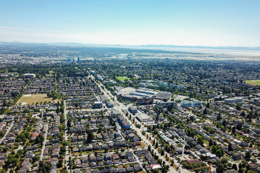 Aerial view over the single-family houses, tree-lined street grid and the Oakridge Centre mall at Cambie Street and 41st Avenue in Oakridge, Vancouver