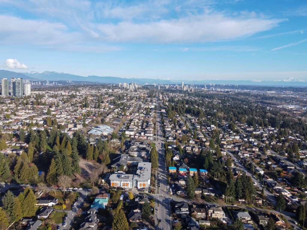 South Slope, Burnaby Aerial view north over detached houses, townhouses and a tree-lined arterial road running downhill, with the Metrotown towers and the North Shore mountains beyond, South Slope, Burnaby